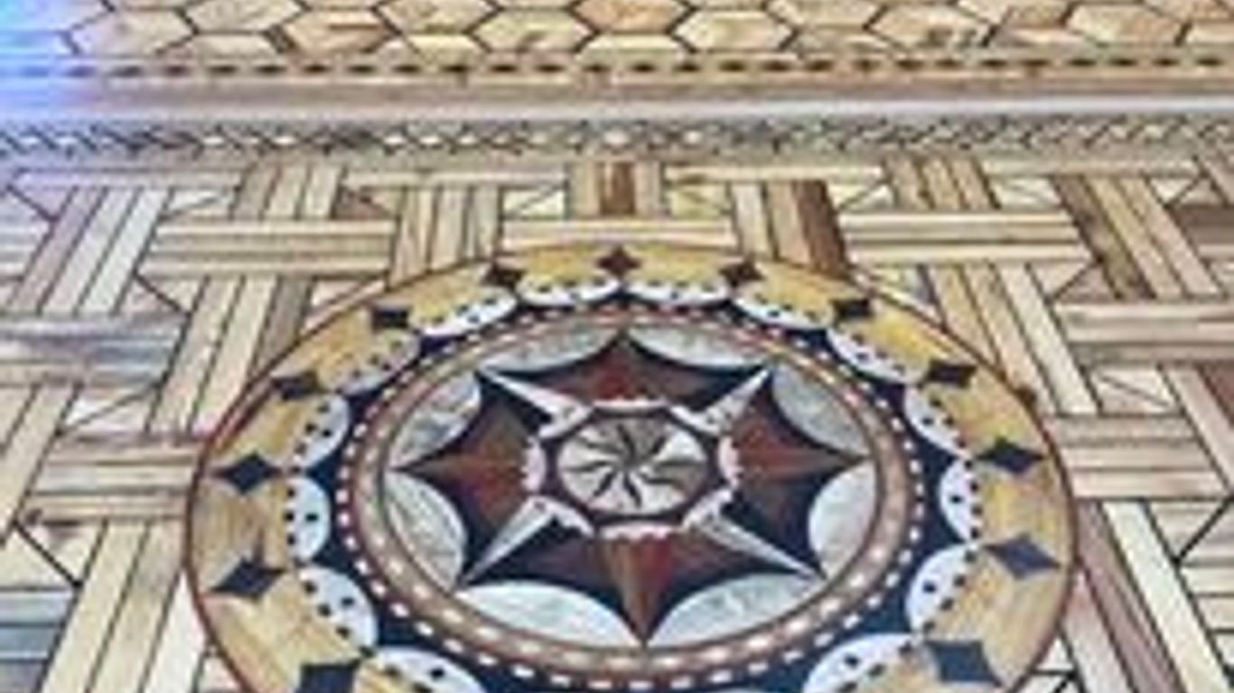 Intricate wooden flooring with geometric and decorative patterns.