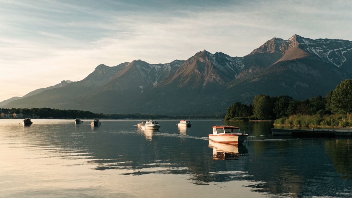 Boats and mountain reflections on Lake Annecy