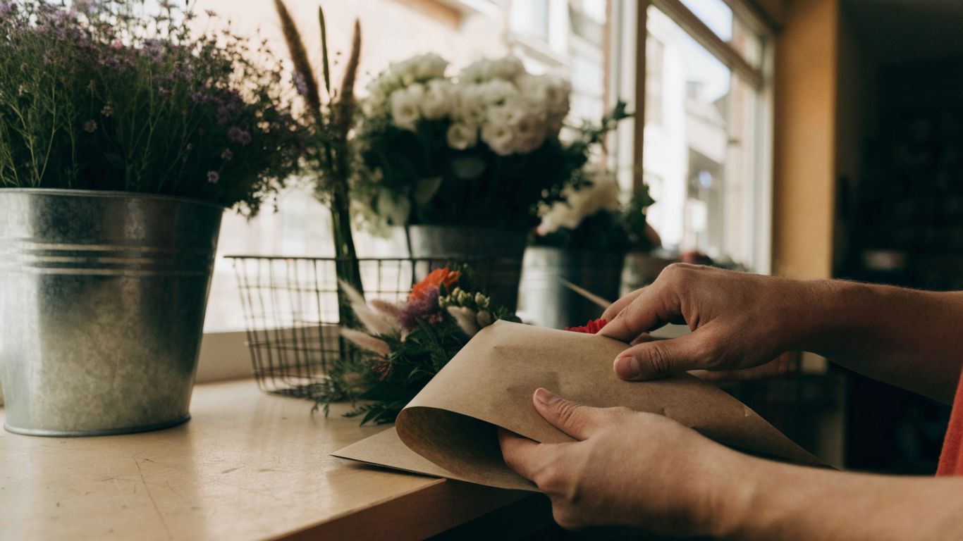 Florist wrapping flowers for delivery