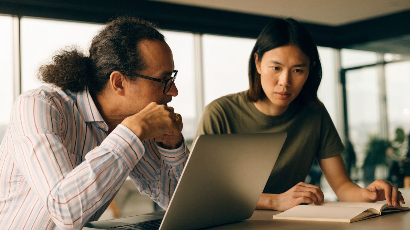 Manager and assignee reviewing a project handoff together