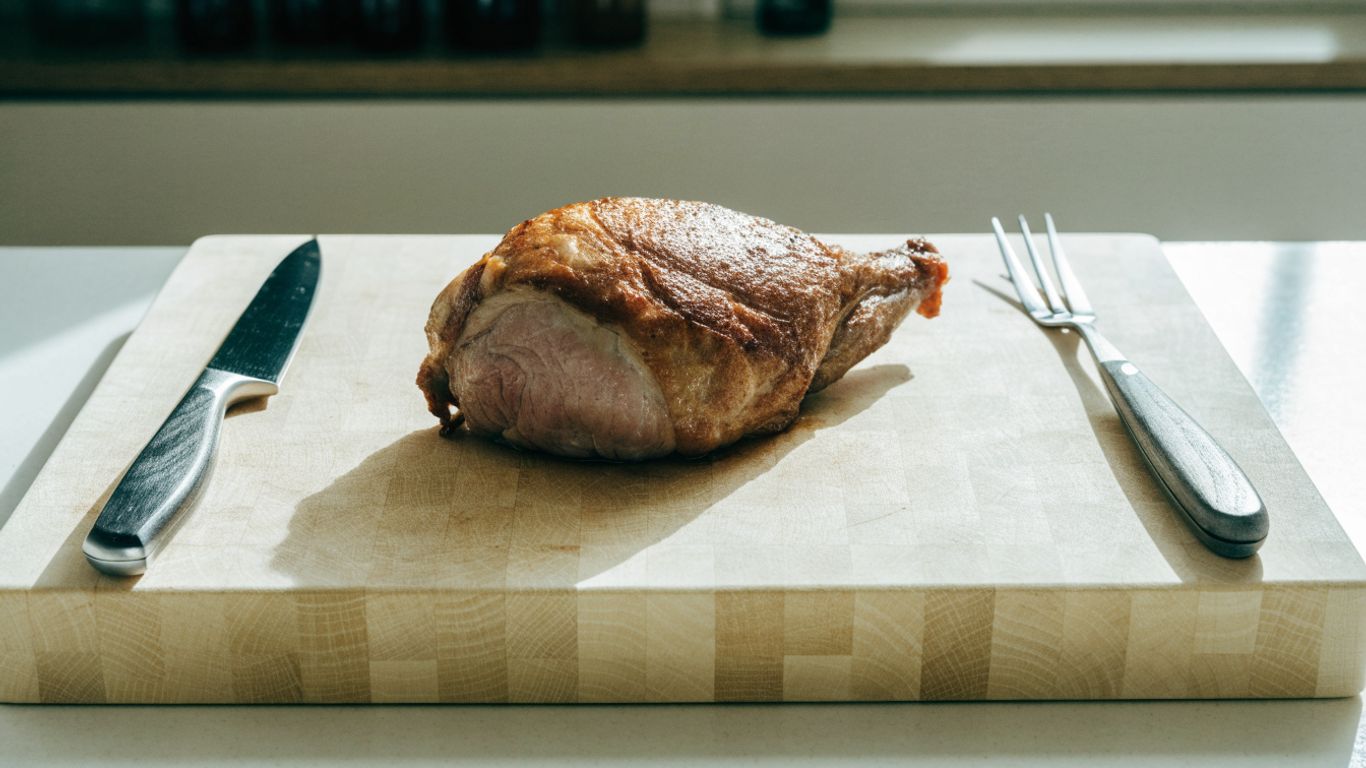 Carving tools beside a resting roast