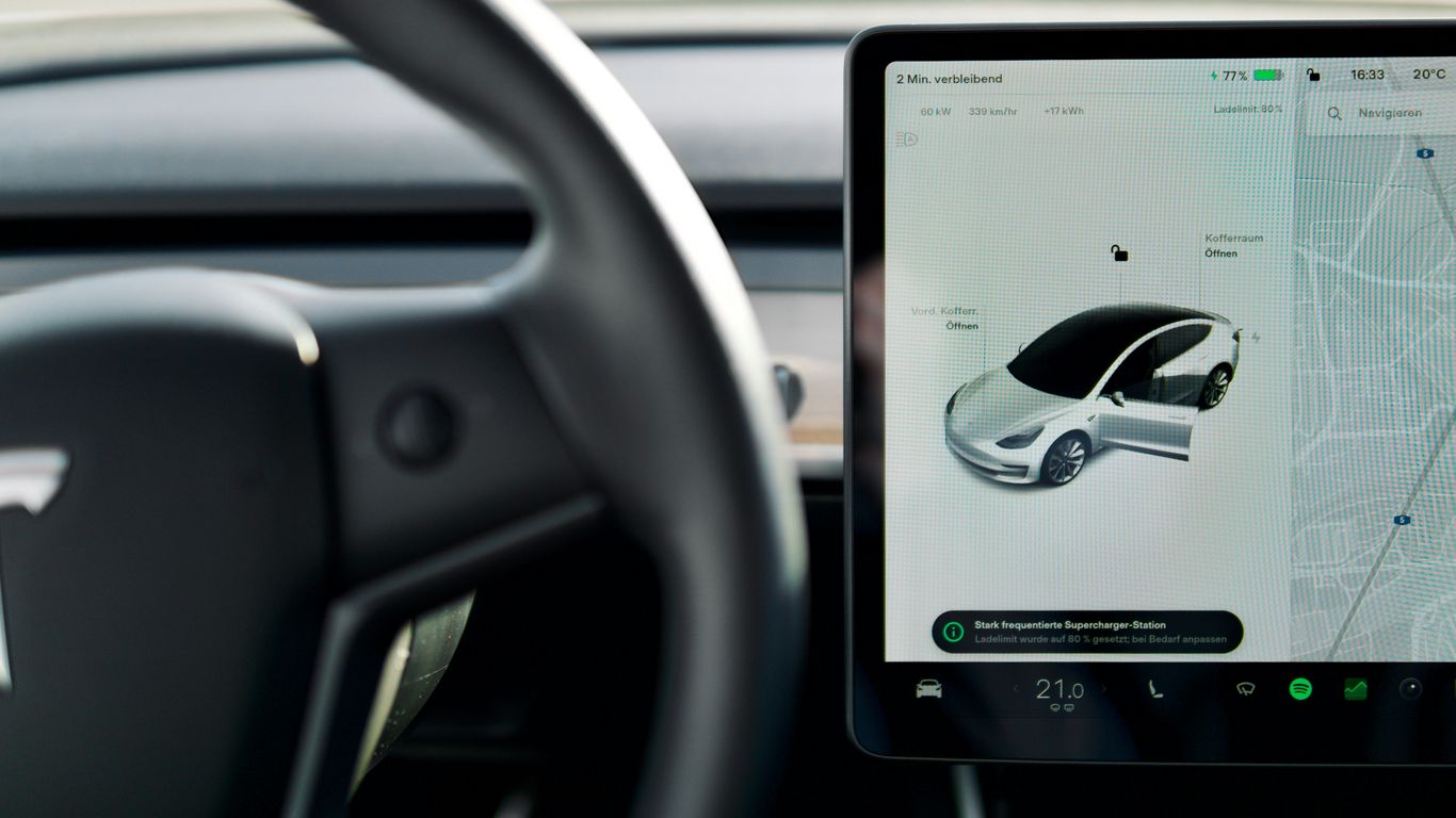 a car dashboard with a screen and a steering wheel