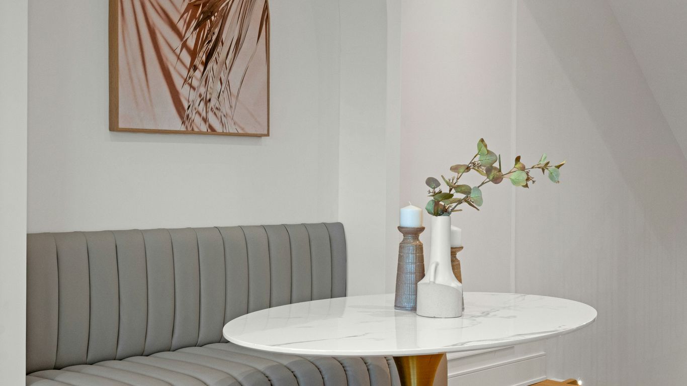 Marble oval dining table in bright interior