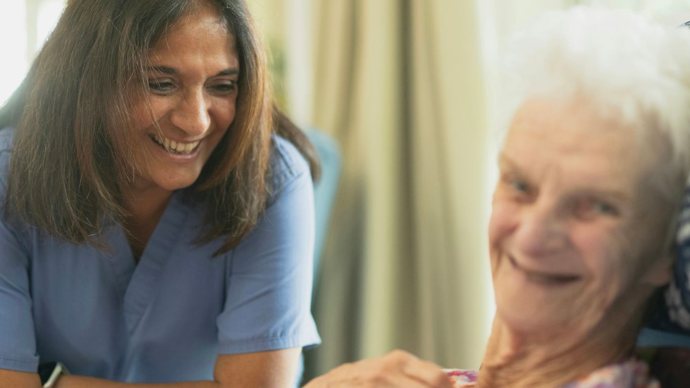 Healthcare professionals providing support to aging patient