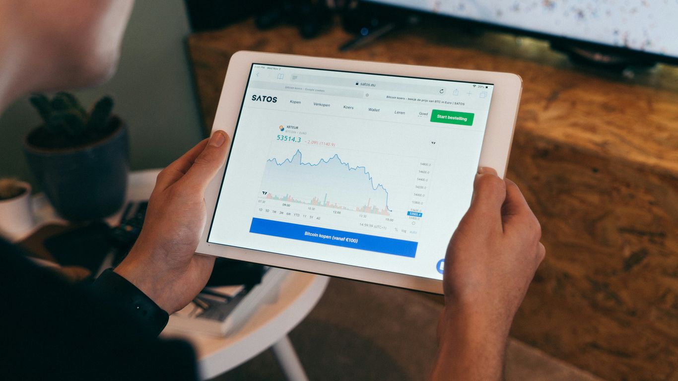 a person holding a tablet with a chart on it