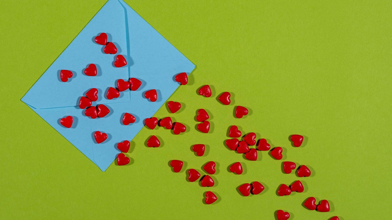 a blue envelope with red hearts coming out of it