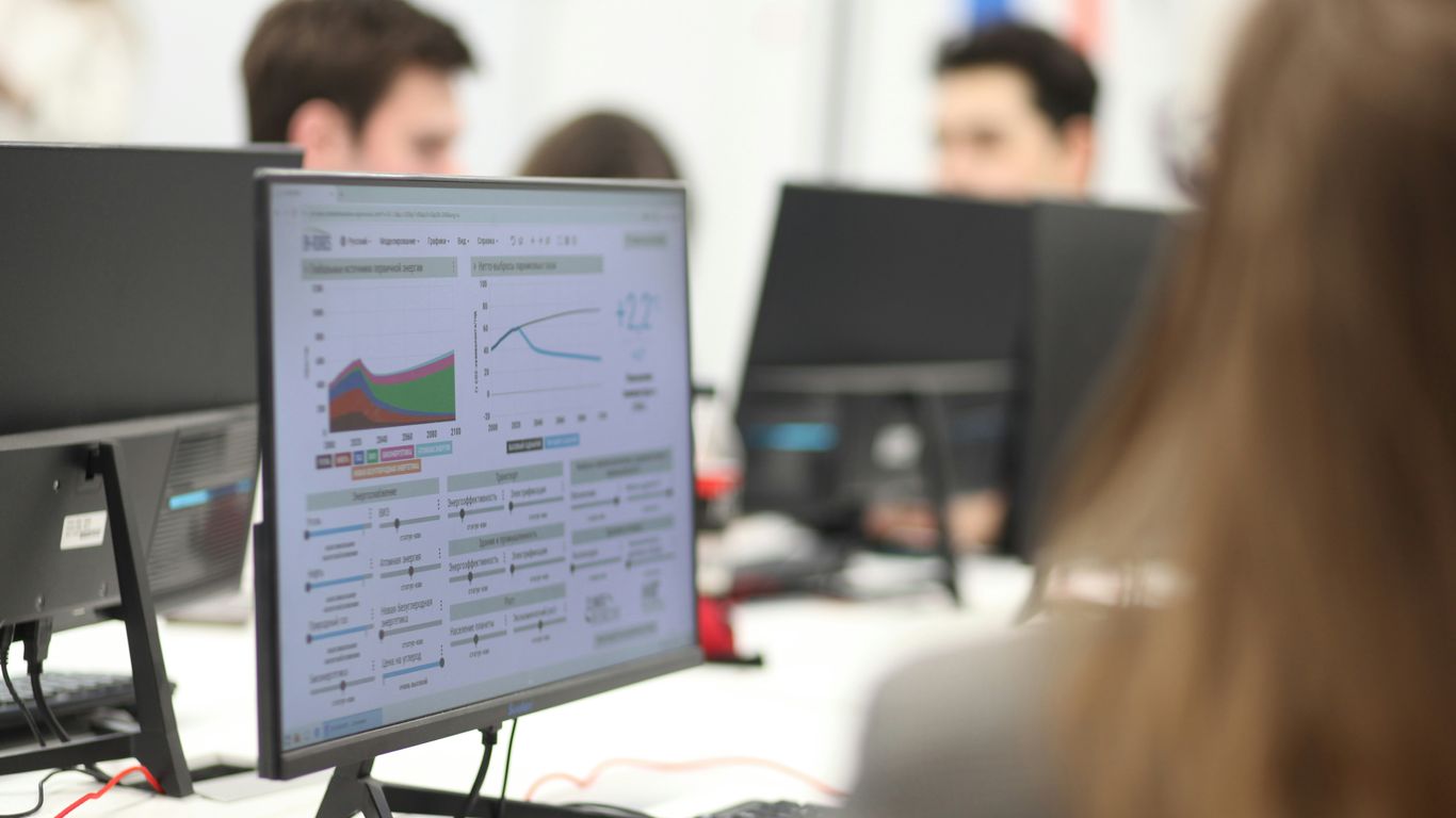 Professional team analyzing digital metrics on screens