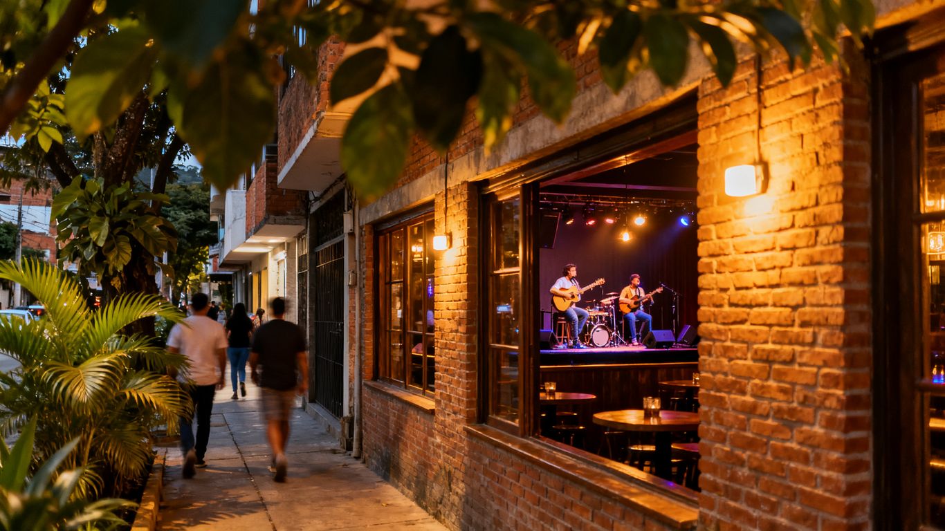 Nighttime street with live music venues in Laureles