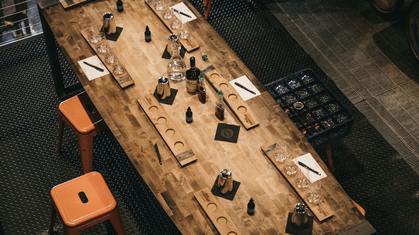 a wooden table topped with lots of bottles of wine