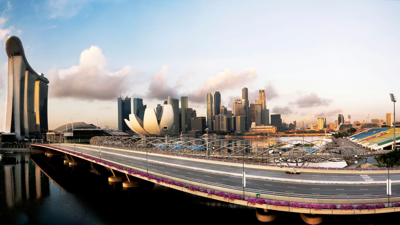 a bridge over a river with a city in the background