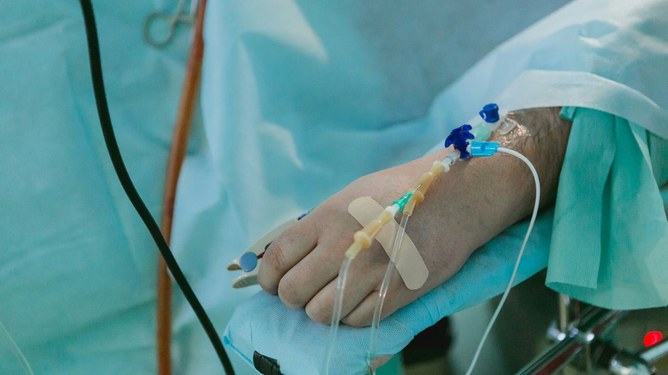 a person in a hospital bed with an iv