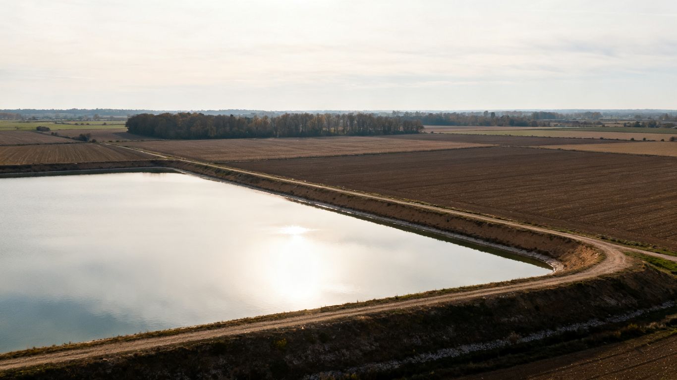 Agricultural reservoir in the middle of fields
