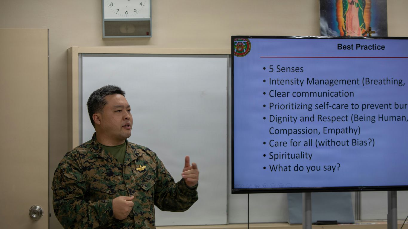 Man in military uniform presenting to a group.