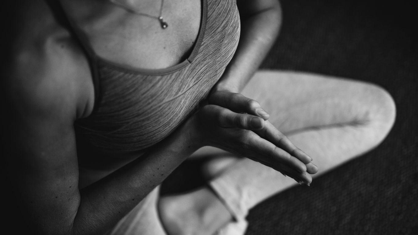 Yoga instructor selecting music for a morning flow