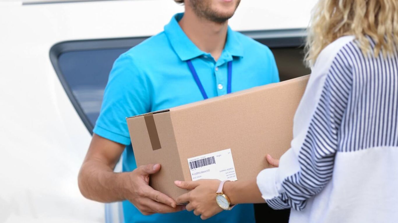 A person delivers a package to another person.