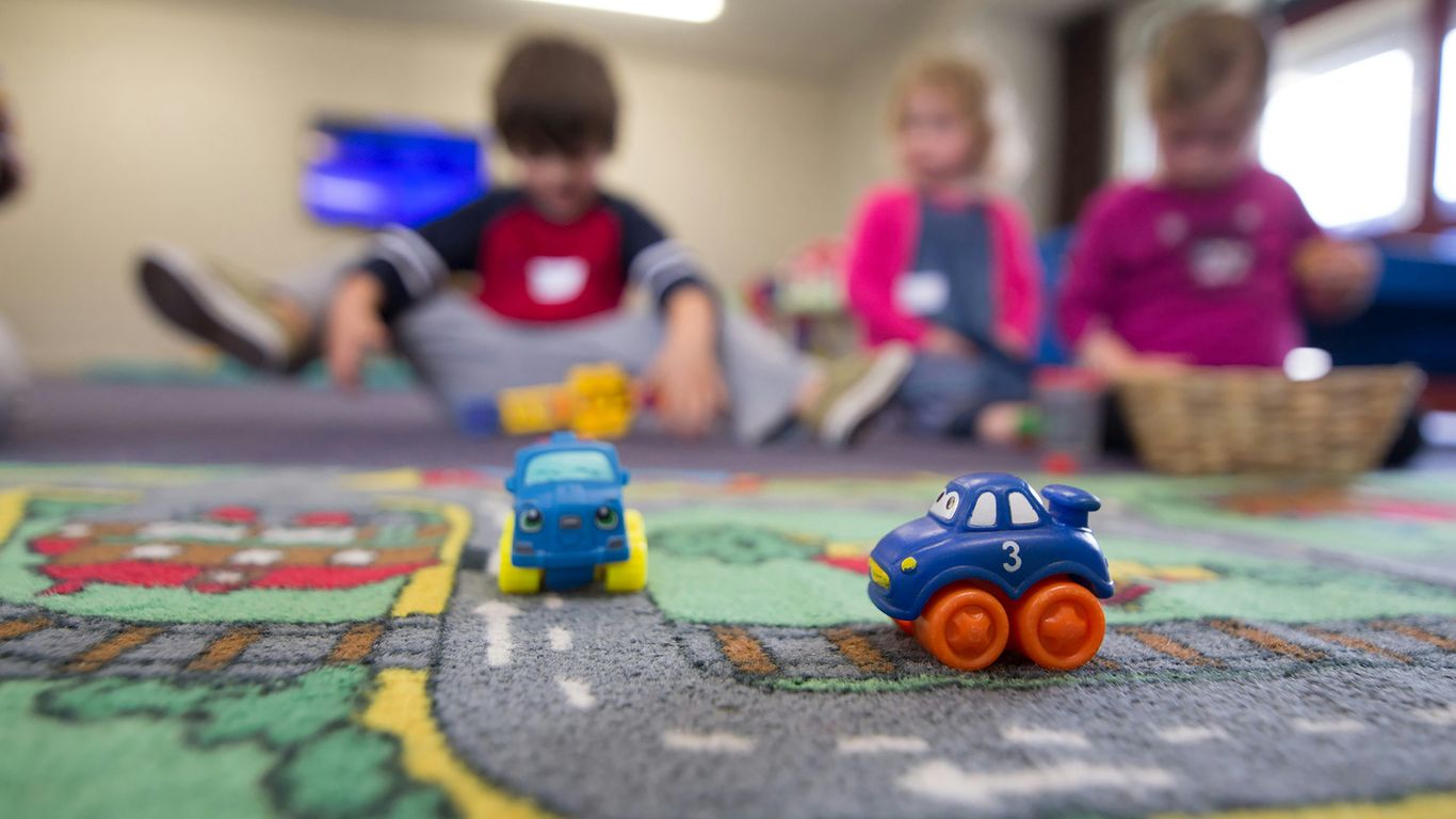 a group of children playing with toys on the floor