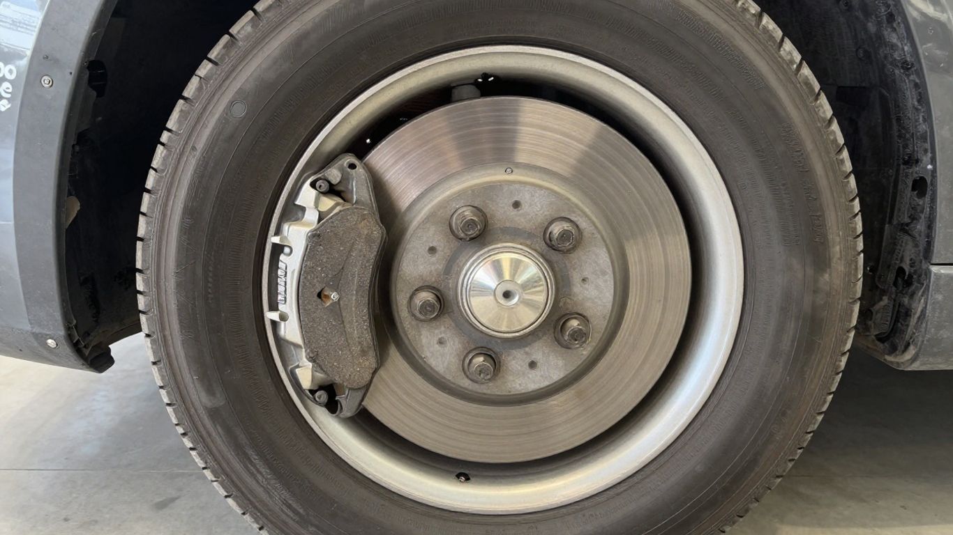 Close view of worn brake pads and rotor