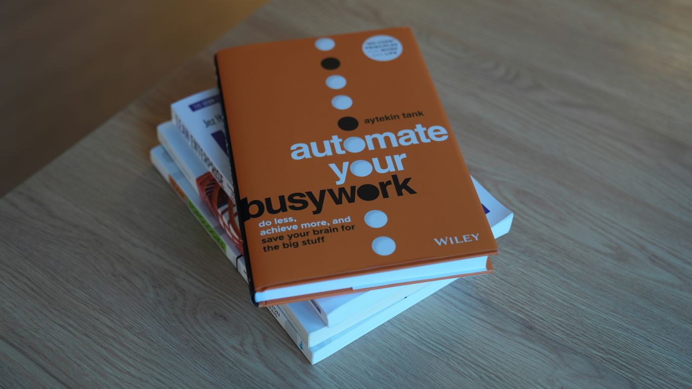 a stack of books sitting on top of a wooden table