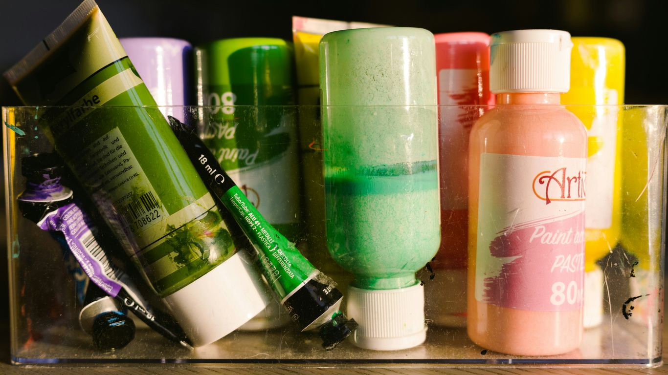 Various tubes and bottles of colorful paint.