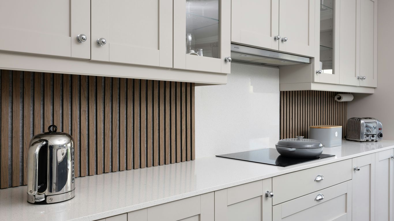 a kitchen with white cabinets and a stove top oven
