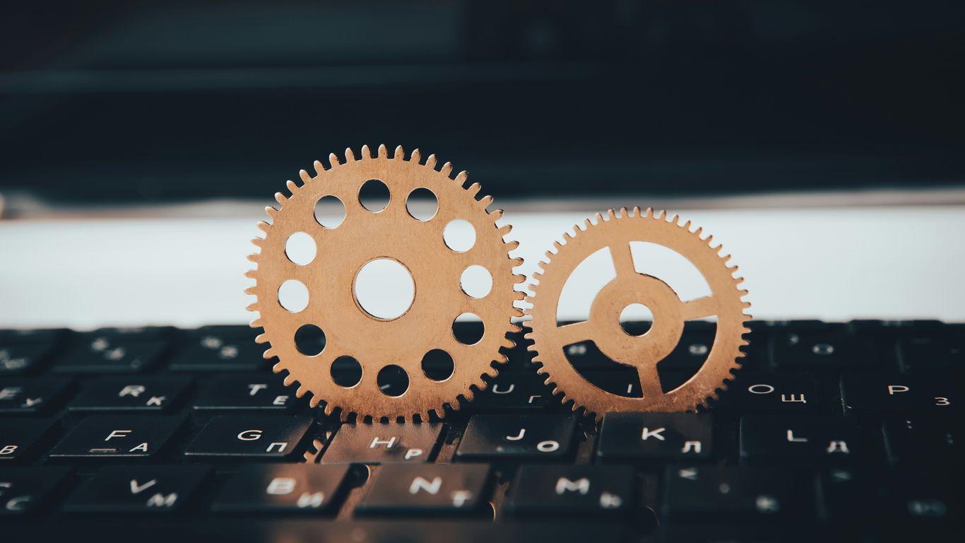 two wooden gears sitting on top of a keyboard