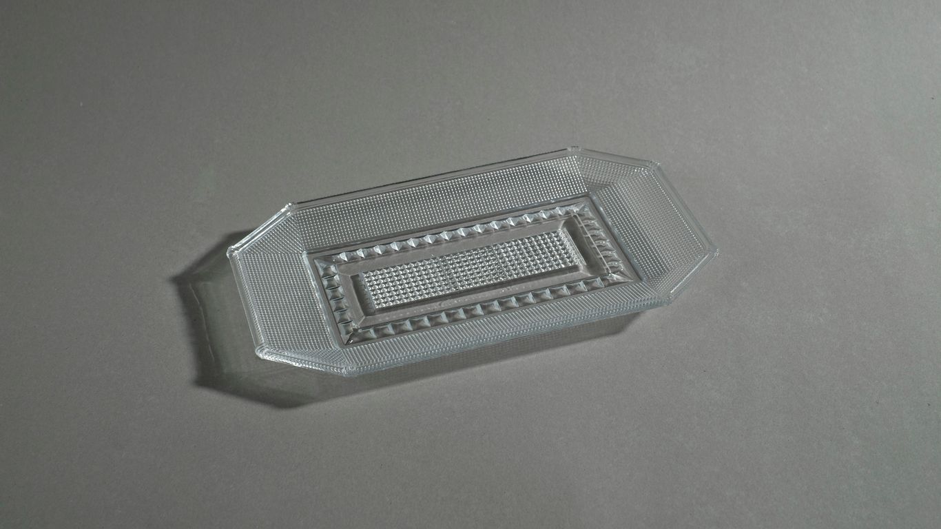 Metallic logo badge inside clear acrylic