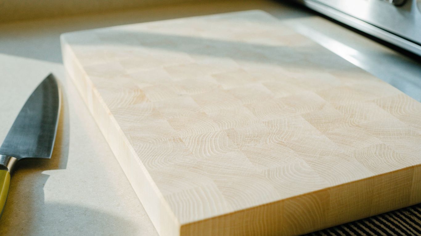 Maple cutting board seated flat on a kitchen counter