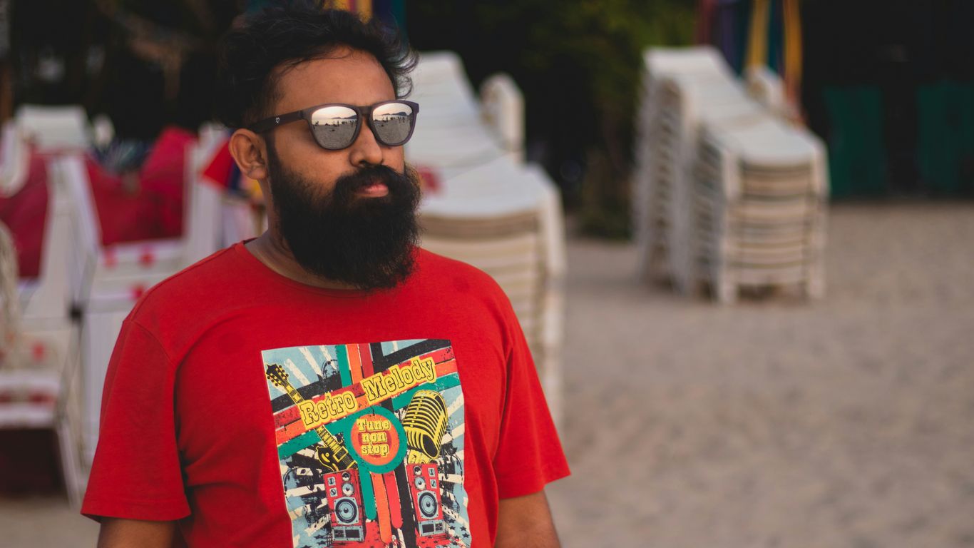 a man with a beard wearing a red shirt