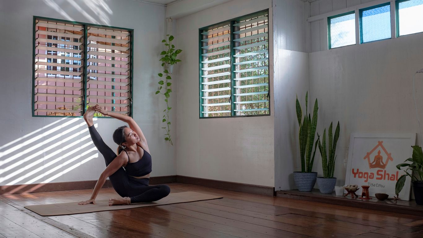 Practicing yoga poses on a thick Gaiam mat