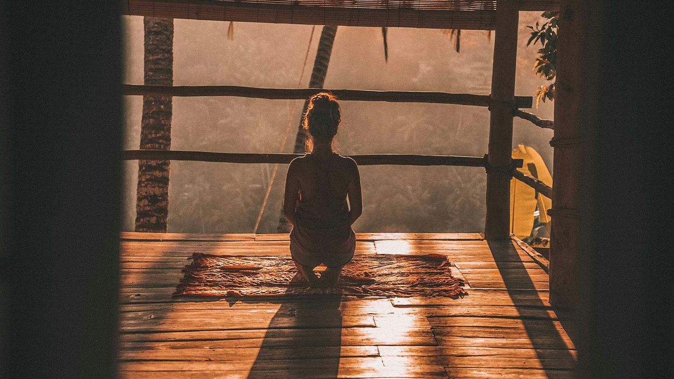 Natural rubber yoga mat beside studio towel