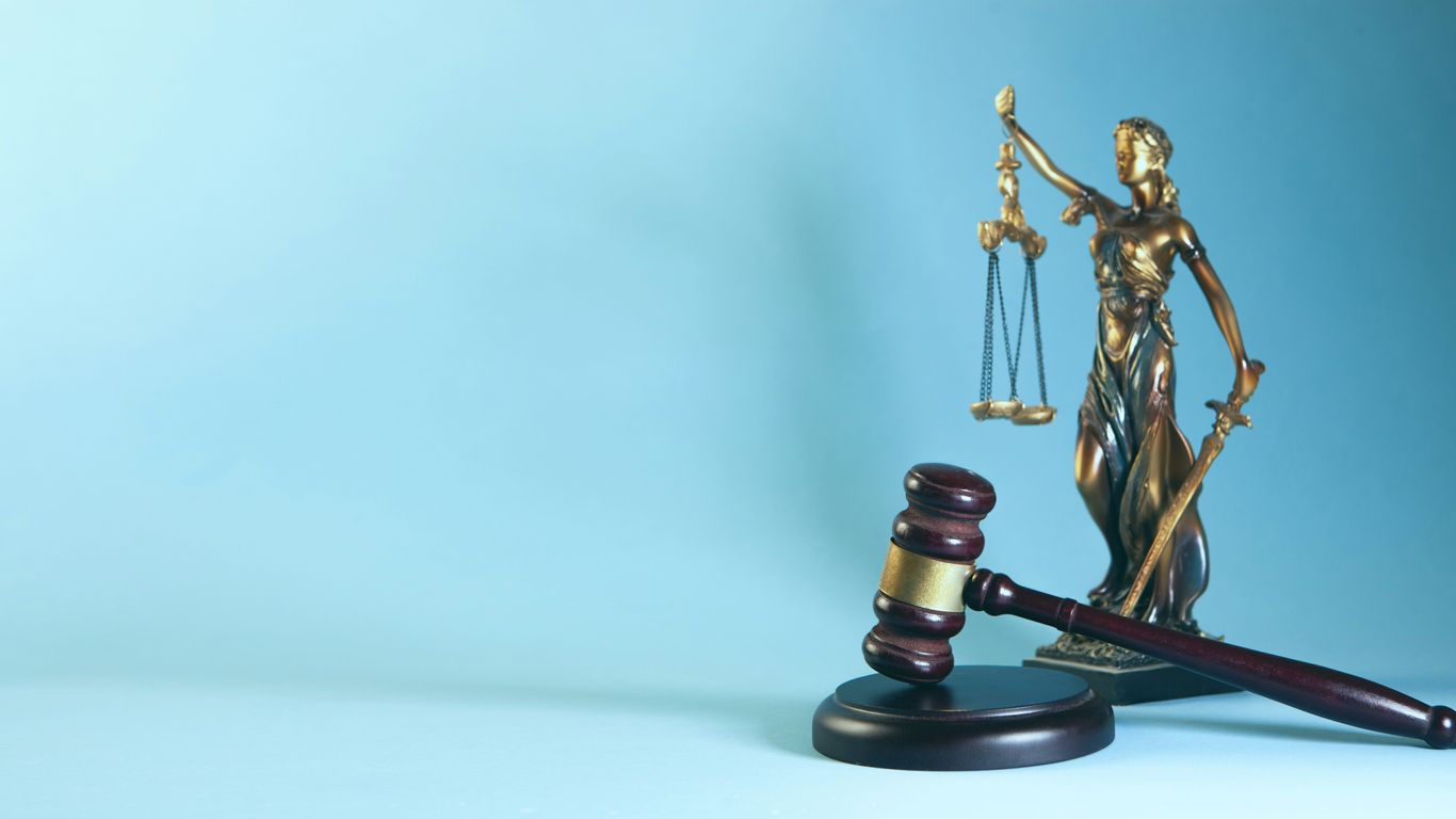 Lady justice and gavel on a blue background