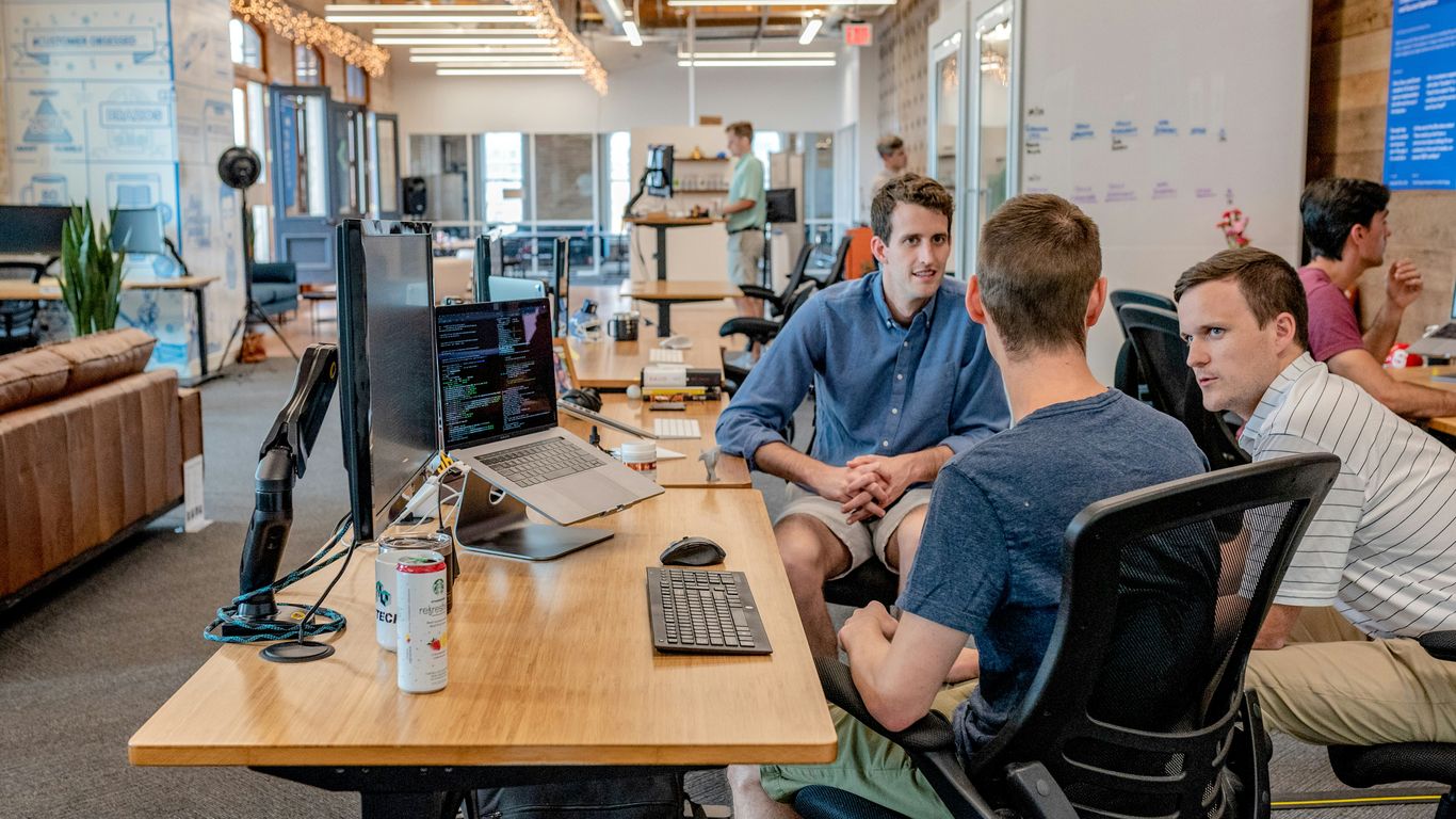 Professional office workers reviewing content strategies at desks