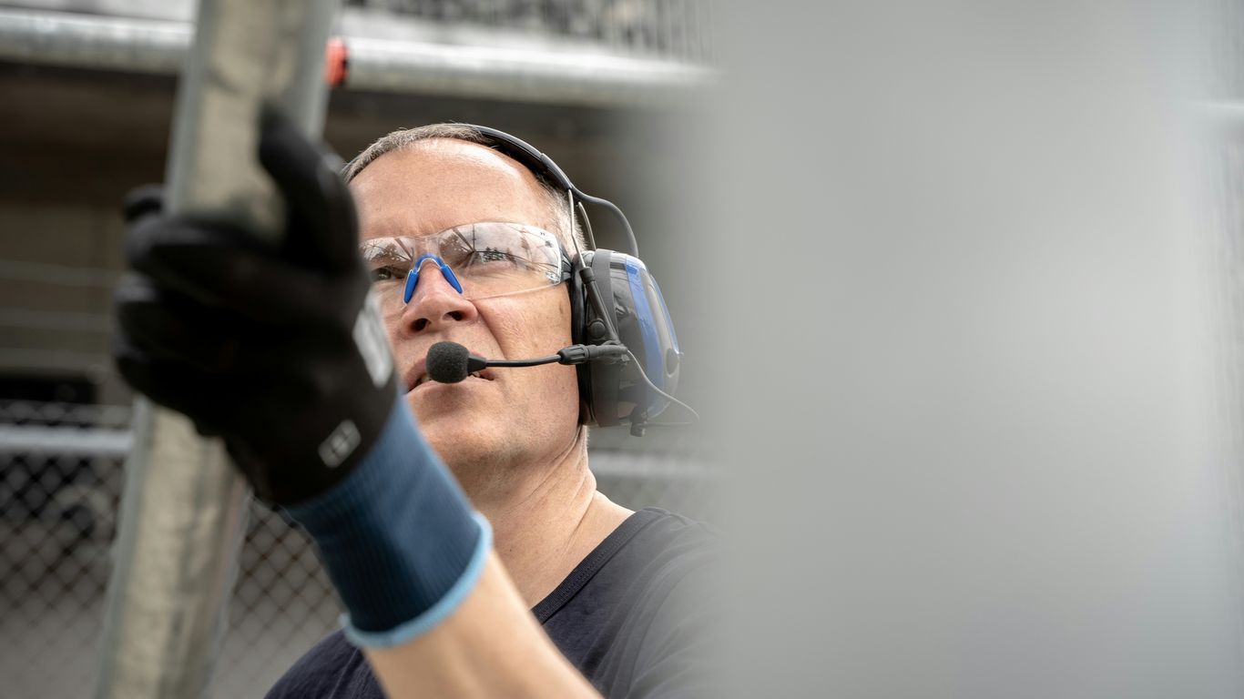 a man wearing a headset and holding a baseball bat