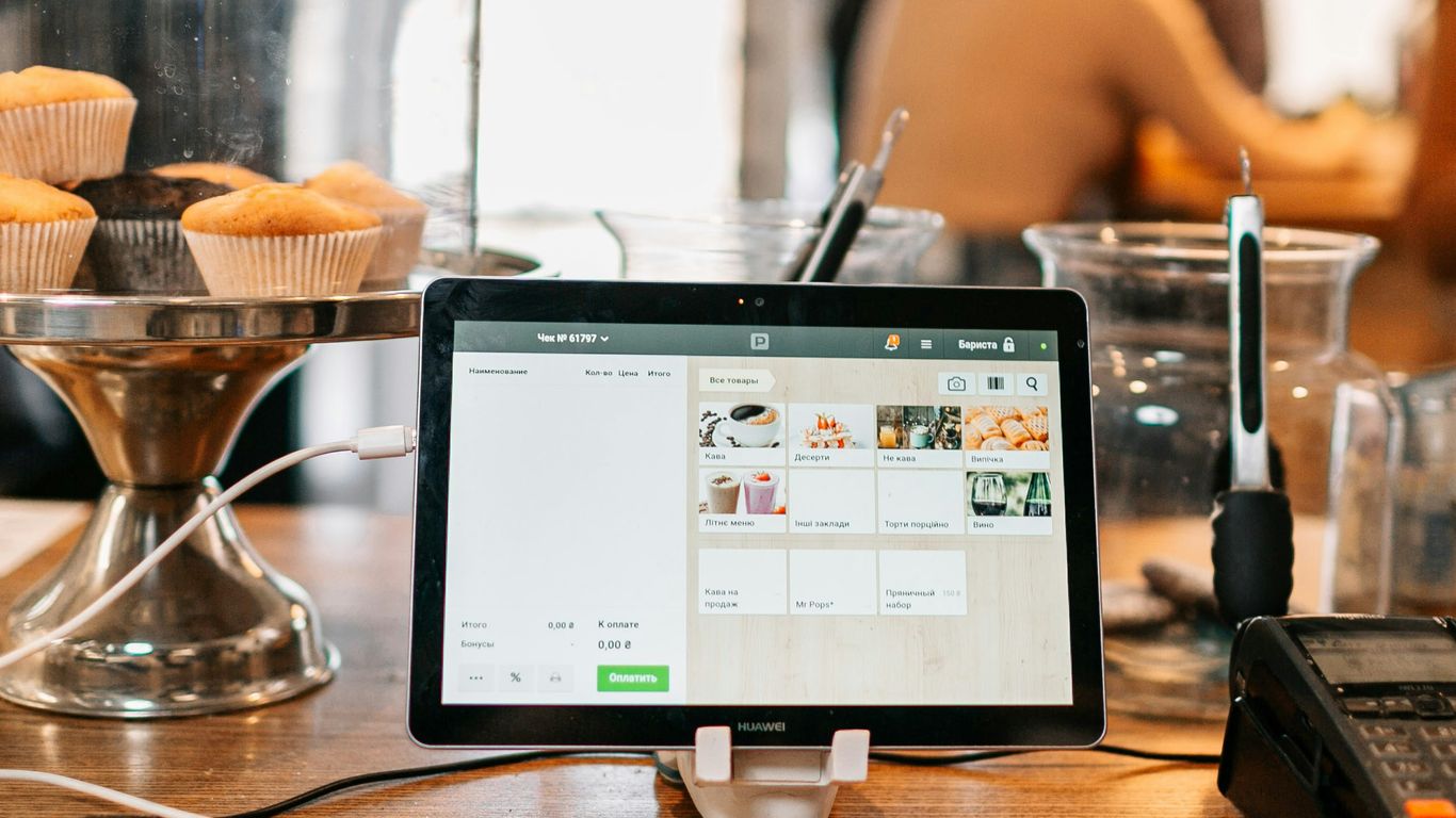 silver ipad on brown wooden table