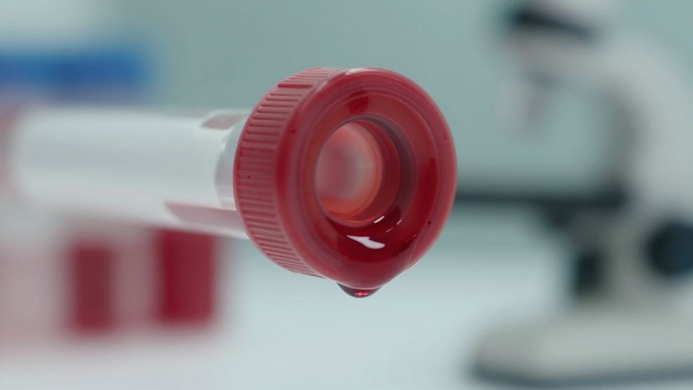 Close-up of red blood cells in a vial.