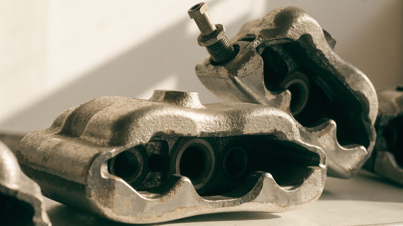 Close view of used Audi brake calipers on a workbench