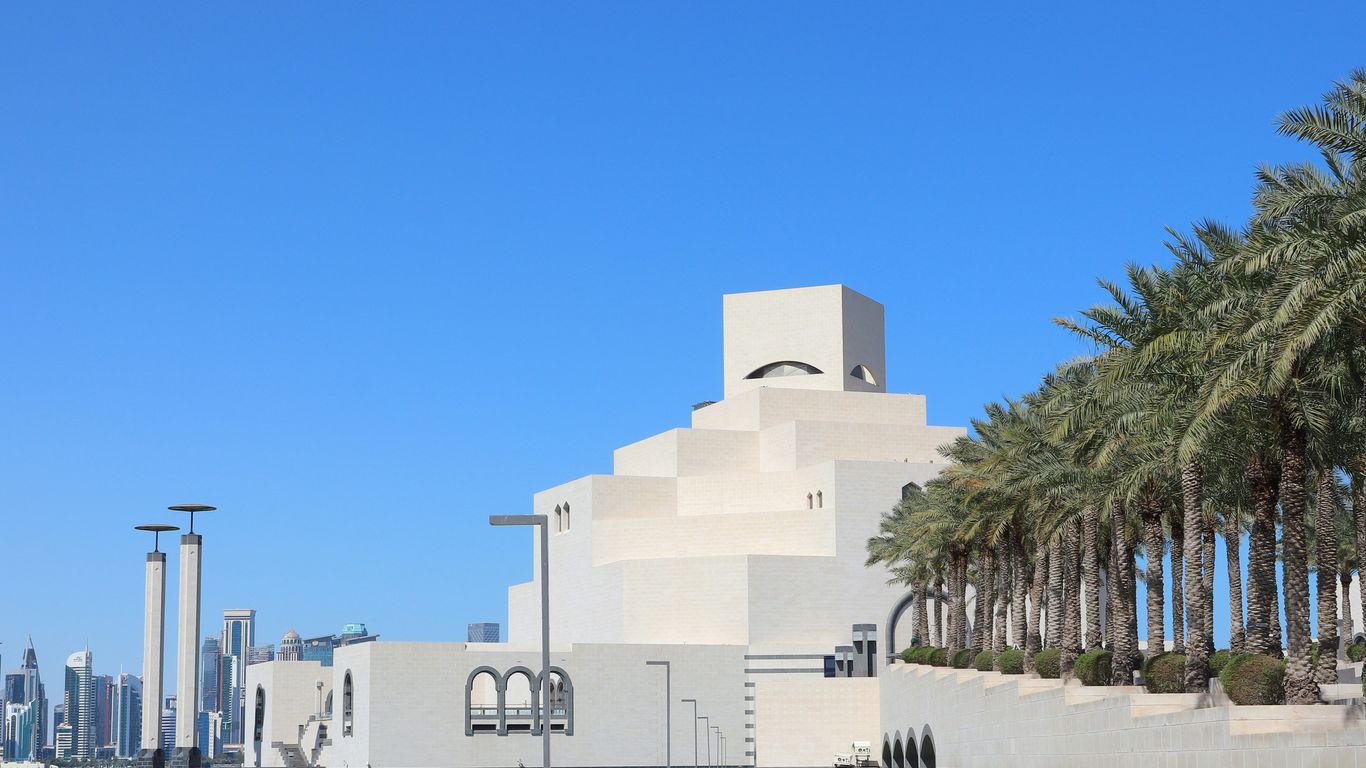 A building with palm trees in front of it