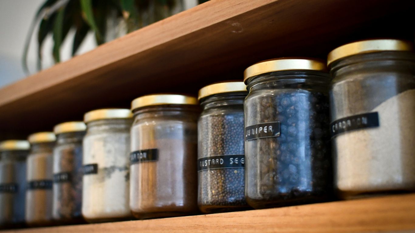 a shelf filled with lots of different types of spices