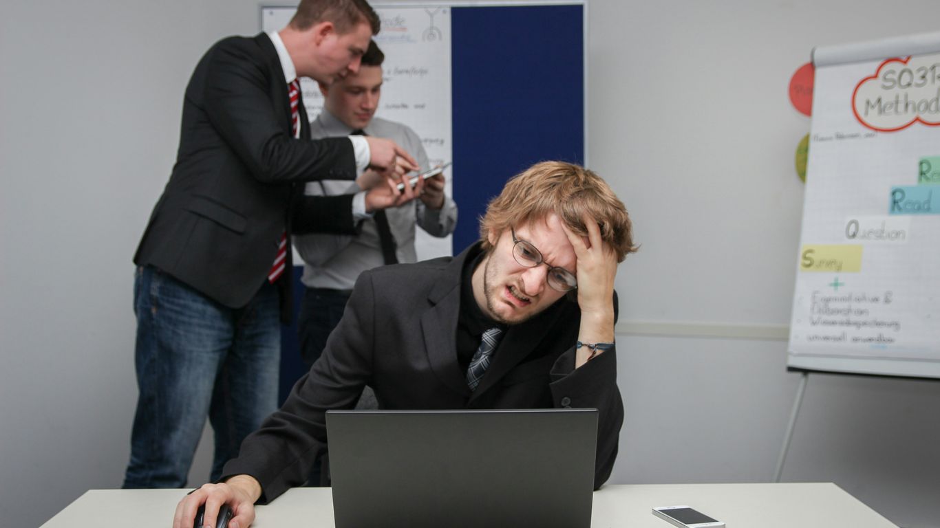 A man sitting in front of a laptop computer