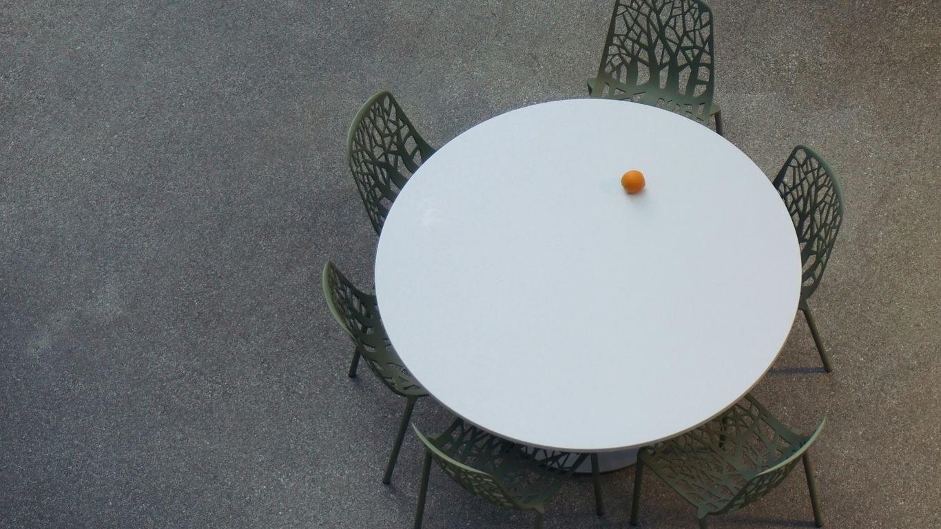 Round marble table in compact dining room
