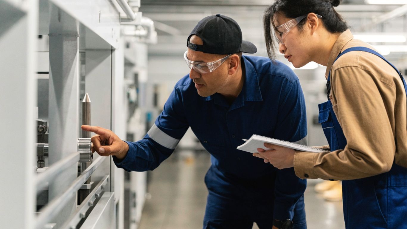 Manufacturing colleagues review production work together