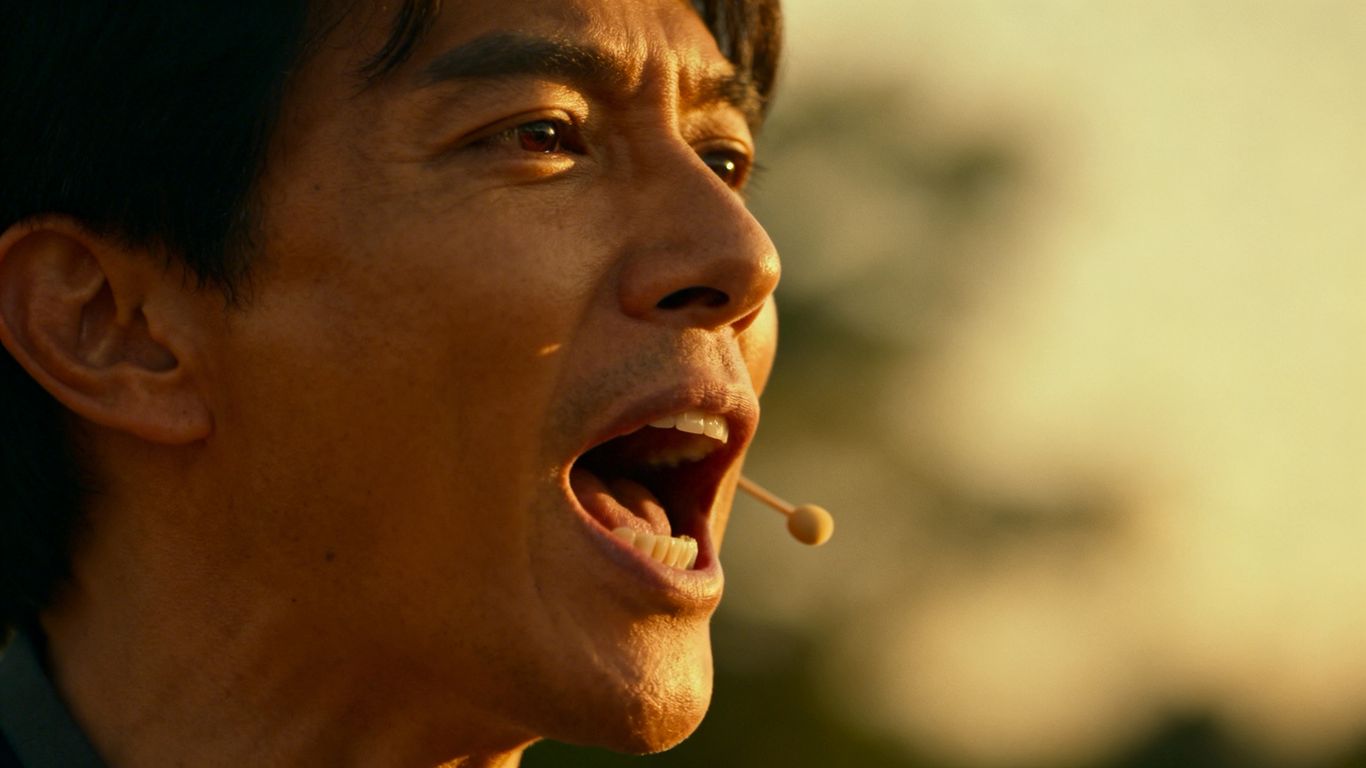 Person speaking with passion into a microphone.