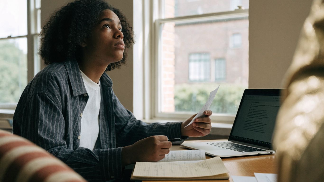 Student reviewing an essay beside handwritten notes