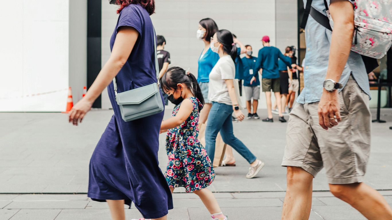 a group of people walking down a street