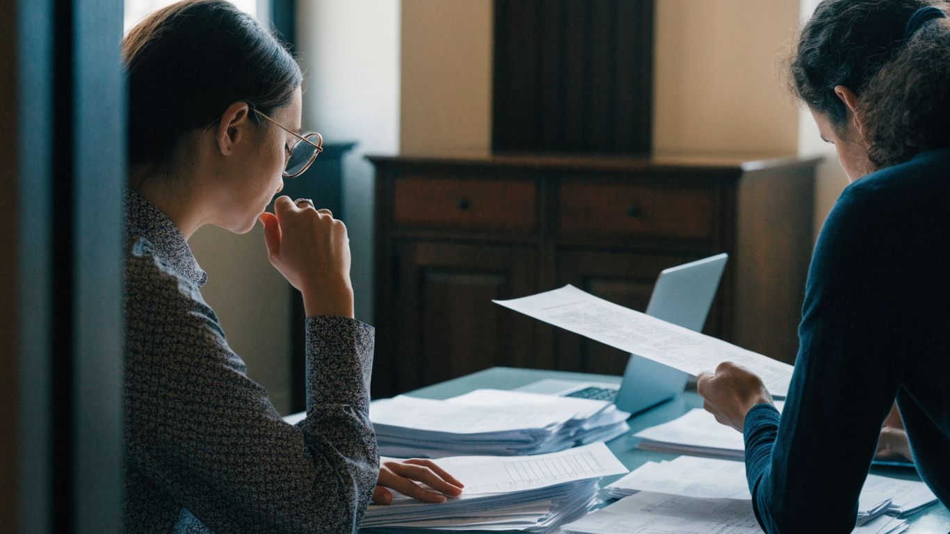 Auditors reviewing organized workpapers together