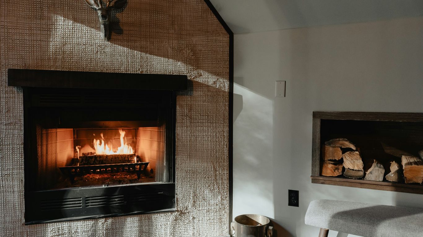 a living room with a fire place and a chair