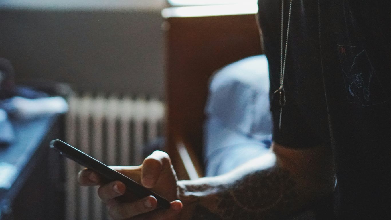 man holding black phone