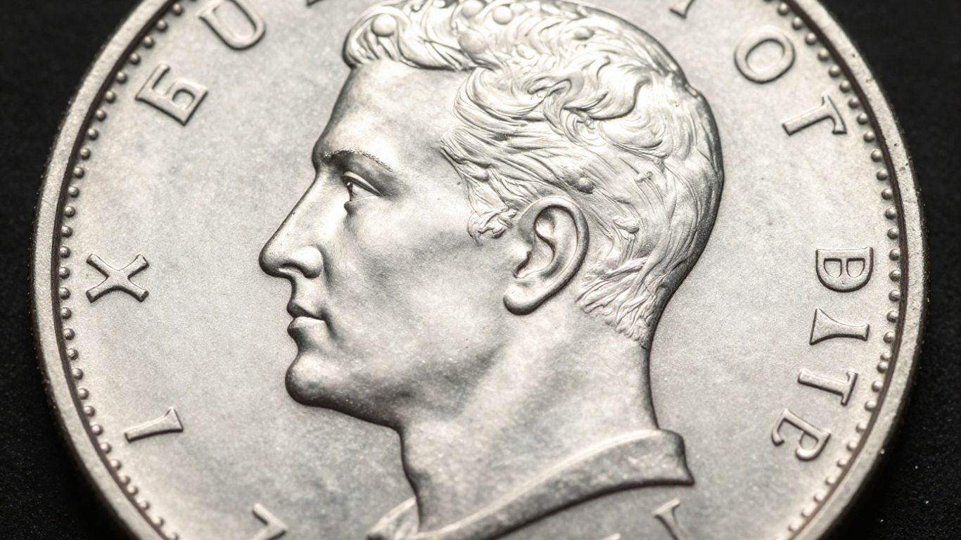 Close-up of a shiny silver coin's surface.