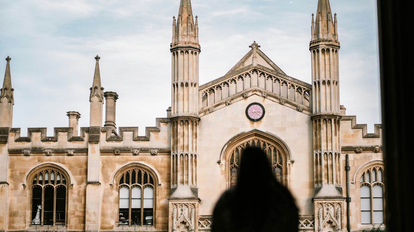 a person standing in front of a large building