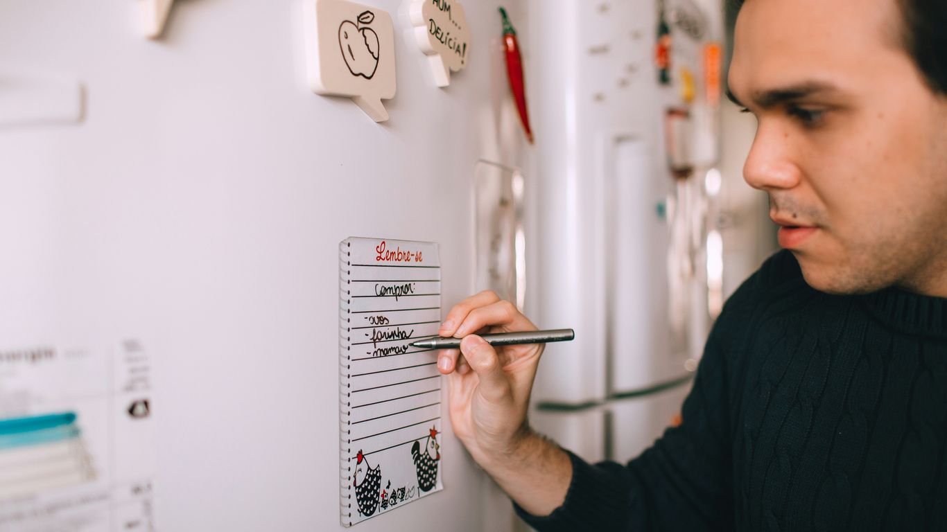 man in black shirt holding pen